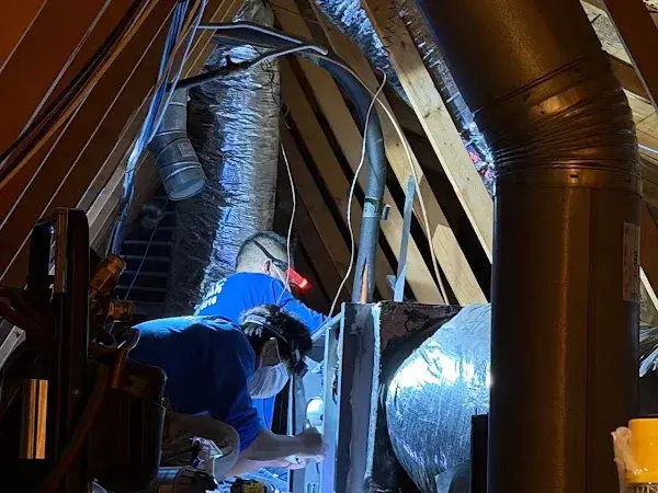 Technicians servicing central AC equipment in an Ontario attic, shared by customer Seng Fong Chang
